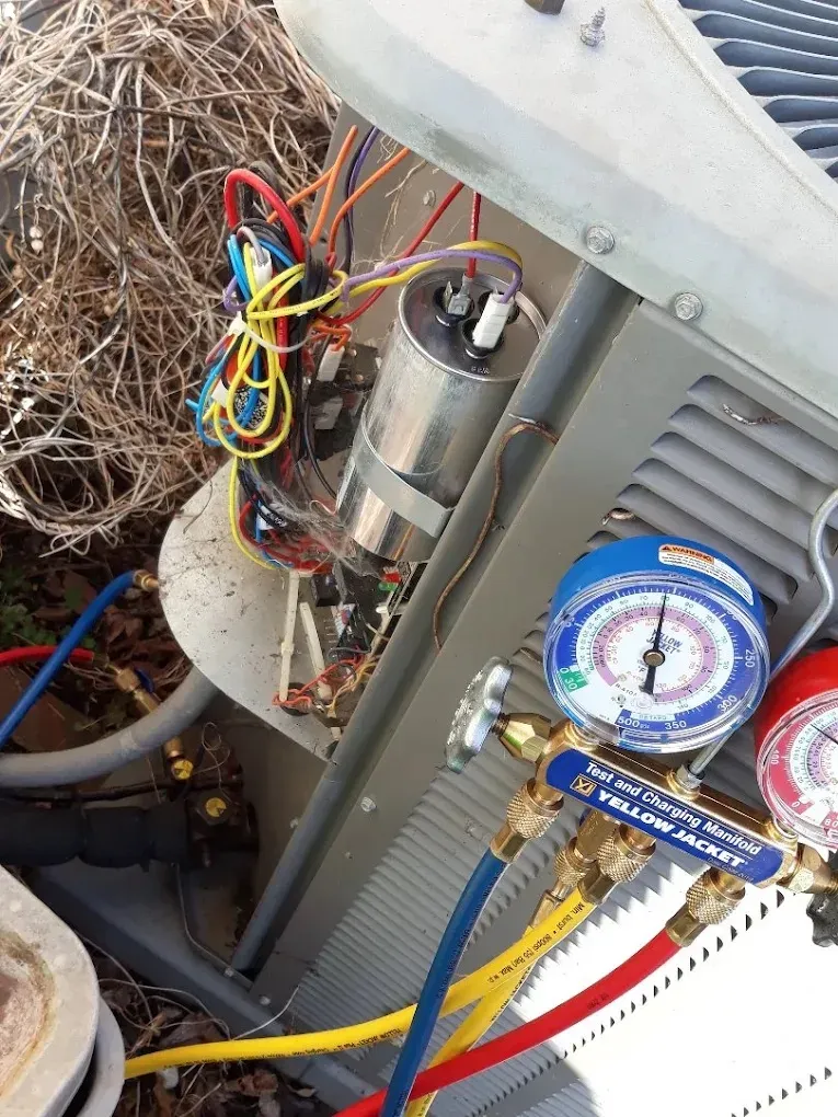 Spring AC Tune-Up Checklist for Knoxville Homes 3 HVAC technician inspecting an air conditioning unit in a residential home